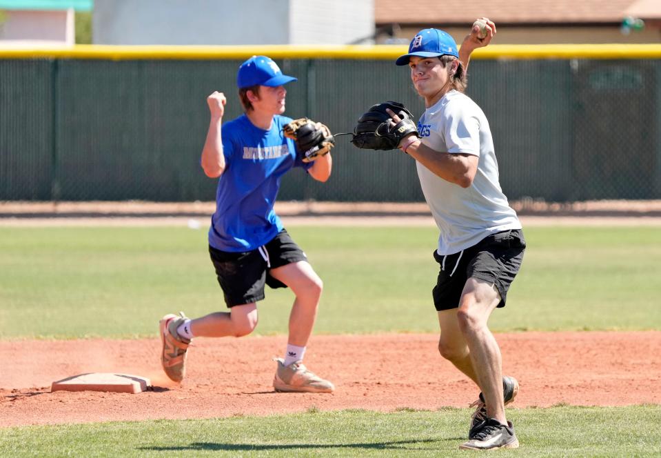 Dobson shortstop Jake Dobson, right, fields a ball during practice in Mesa on April 17, 2024. Dobson and his teammates have broken the Arizona record for the number of stolen bases during a game.