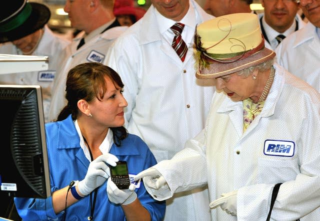 The Queen looking at a Blackberry