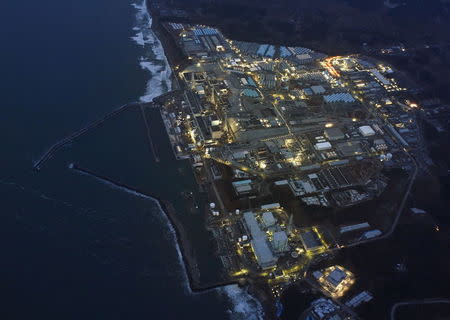 Tokyo Electric Power Co.'s (TEPCO) tsunami-crippled Fukushima Daiichi nuclear power plant is illuminated for decommissioning operation in the dusk in Okuma town, Fukushima prefecture, Japan, in this aerial view photo taken by Kyodo March 10, 2016, a day before the five-year anniversary of the March 11, 2011 earthquake and tsunami disaster. Mandatory credit REUTERS/Kyodo