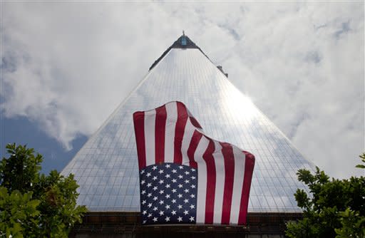 An American flag, draped on the side of One World Trade Center, flaps in the wind, Thursday, June 14, 2012 in New York. President Barack Obama is scheduled to visit the site later Thursday. (AP Photo/Mark Lennihan)