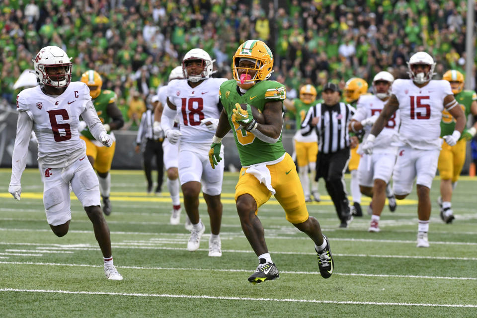 Oregon running back Bucky Irving (0) runs past Washington State defensive back Chau Smith-Wade (6) on his way to a touchdown during the second half of an NCAA college football game Saturday, Oct. 21, 2023, in Eugene, Ore. (AP Photo/Andy Nelson)