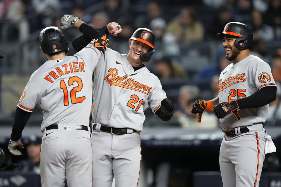 Baltimore Orioles' Austin Hays (21) and Anthony Santander (25) celebrate with Adam Frazier (12) after Frazier hit a three-run home run against the New York Yankees during the seventh inning of a baseball game Wednesday, May 24, 2023, in New York. (AP Photo/Frank Franklin II)