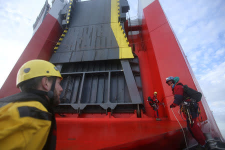 Greenpeace volunteers board a ship carrying Volkswagen vehicles for import as it sails up the Thames Estuary towards the port of Sheerness, Britain, September 21, 2017. Kristian Buus/Greenpeace handout via REUTERS