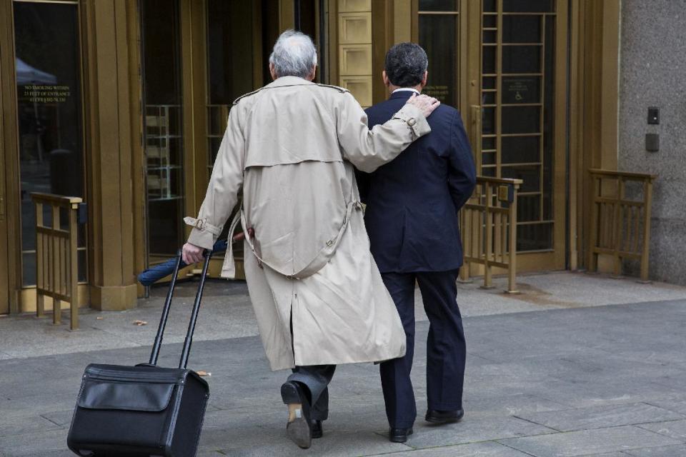 Former Goldman Sachs and Procter & Gamble Co. board member Rajat Gupta, right, arrives at court in New York Wednesday, Oct. 24, 2012. Gupta is to be sentenced after being found guilty insider trading by passing secrets between March 2007 and January 2009 to a billionaire hedge fund founder who used the information to make millions of dollars. At left is Gupta's attorney Gary Naftalis. (AP Photo/Craig Ruttle)