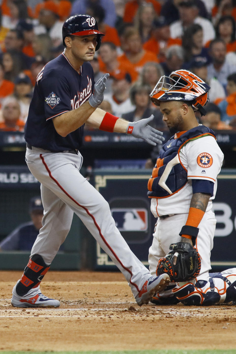 Washington Nationals' Ryan Zimmerman celebrates past Houston Astros catcher Martin Maldonado after his home during the second inning of Game 1 of the baseball World Series Tuesday, Oct. 22, 2019, in Houston. (AP Photo/Matt Slocum)