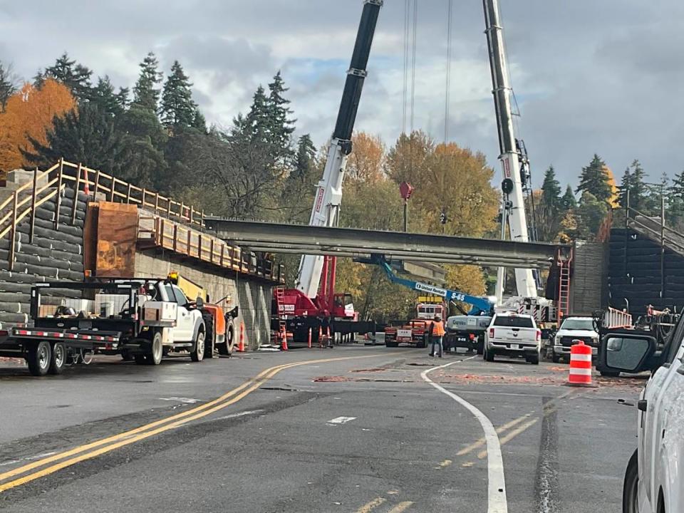 Crews place girders into place on an overpass for the 167 Completion Project over 12th Street East in Fife Sat. Nov. 11, 2023.