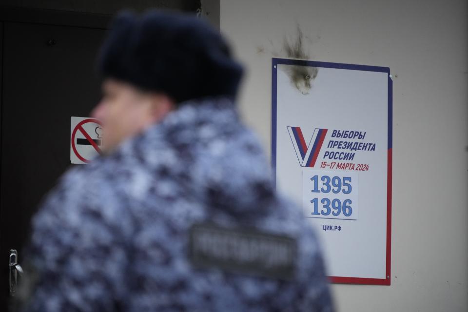 A police officer guards the area after a woman threw a Molotov cocktail onto the roof of a school that houses a polling station during a presidential election in St. Petersburg, Russia, Friday, March 15, 2024. Voters in Russia are heading to the polls for a presidential election that is all but certain to extend President Vladimir Putin's rule after he clamped down on dissent. (AP Photo)