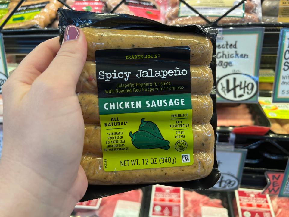 The writer holds a pack of spicy jalapeno-chicken sausage