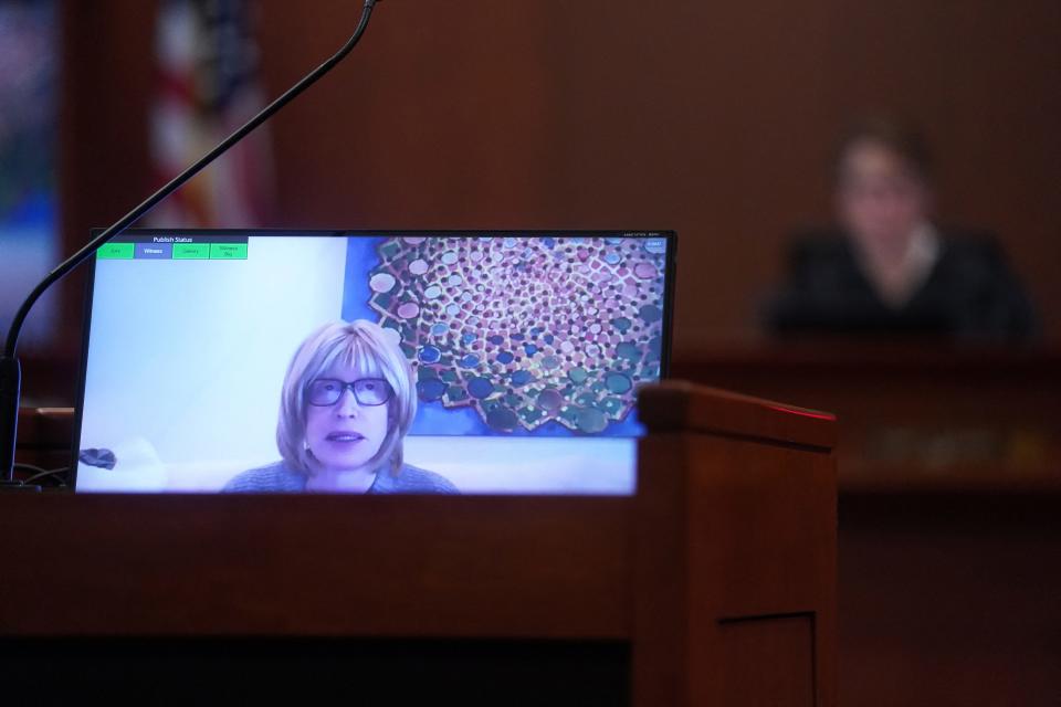 Tracey Jacobs shown on a video screen in court