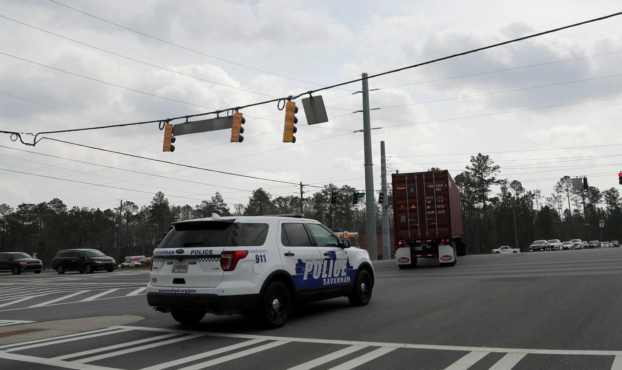 A Savannah Police vehicle waits to turn off of Benton Boulevard onto Jimmy Deloach Parkway.