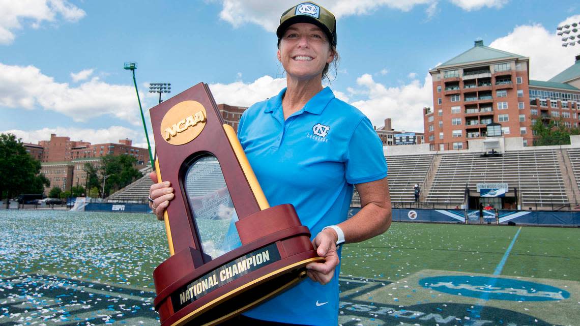 UNC women’s lacrosse head coach Jenny Levy holds the trophy for the NCAA National Championship title Sunday, May 29, 2022, after North Carolina defeated Boston College at Homewood Field at John Hopkins University. It’s UNC’s third NCAA championship.