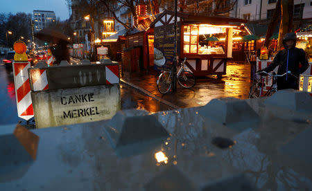 A concrete barricade with a graffiti treading "Thank you Merkel" blocks the entrance to the Christmas market prior to its official opening in Frankfurt, Germany, November 27, 2017. REUTERS/Kai Pfaffenbach?