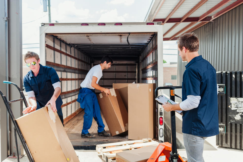 Workers loading a delivery truck.