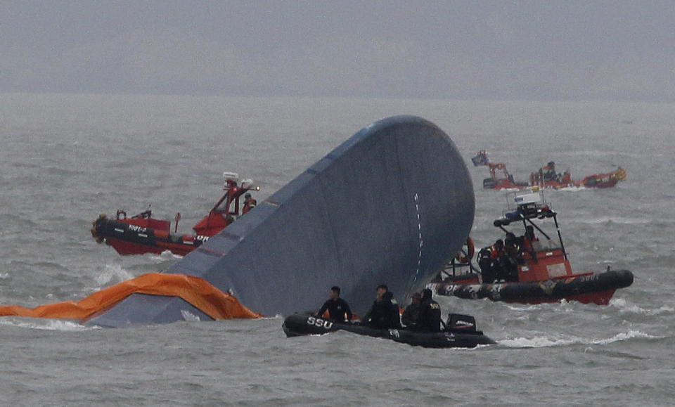 South Korean Coast Guard officers search for missing passengers aboard a sunken ferry in the water off the southern coast near Jindo, South Korea, Thursday, April 17, 2014. Strong currents, rain and bad visibility hampered an increasingly anxious search Thursday for more than 280 passengers still missing a day after their ferry flipped onto its side and sank in cold waters off the southern coast of South Korea.(AP Photo/Ahn Young-joon)