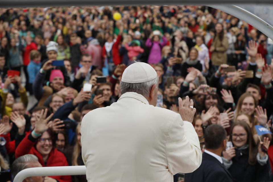 Pope Francis greets the crowd on his Popemobile as he arrives for a meeting with youths, at the Cathedral Square in Vilnius, Lithuania, Saturday Sept. 22, 2018. Pope Francis arrived in Lithuania for a two-day visit Saturday. (AP Photo/Mindaugas Kulbis)