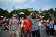 <p>A group of men gather in Union Square in New York to watch the total solar eclipse on Aug. 21, 2017. (Gordon Donovan/Yahoo News) </p>