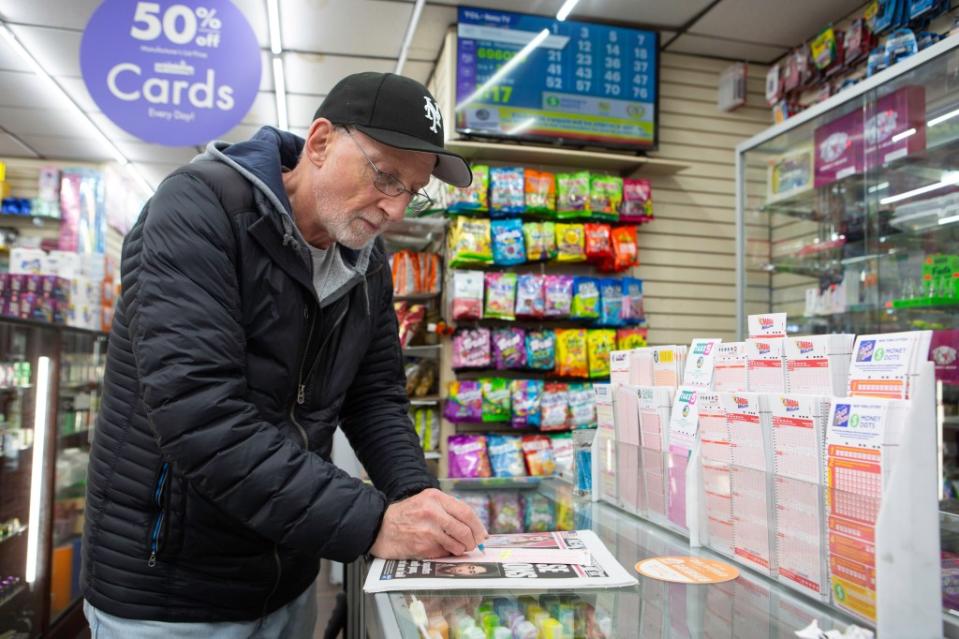 Arthur Stavola buys his Power Ball ticket at Bayside Smoke Shop on Bell Blvd in Bayside, NY. James Messerschmidt