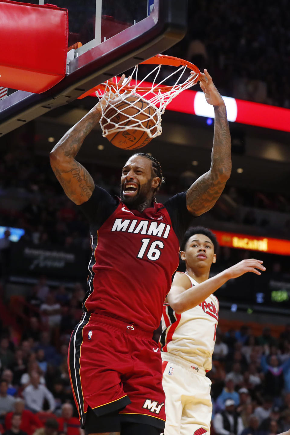 Miami Heat forward James Johnson (16) dunks against Portland Trail Blazers guard Anfernee Simons (1) during the second half of an NBA basketball game, Sunday, Jan. 5, 2020, in Miami. The Heat defeated the Trail Blazers 122-111. (AP Photo/Wilfredo Lee)
