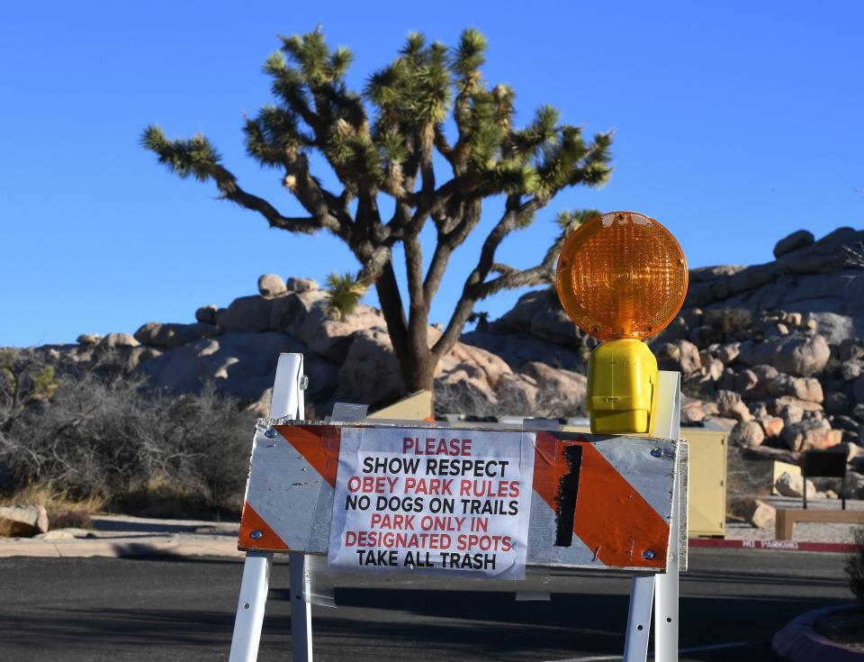 Signs placed by staff at a closed campground in the Joshua Tree National Park after the federal government's partial shutdown caused park rangers to stay home and campgrounds to be shut, at the park in California on January 3, 2019. - US President Donald Trump warned the US federal government may not fully reopen any time soon, as he stood firm on his demand for billions of dollars in funding for a border wall with Mexico. (Photo by Mark RALSTON/AFP/Getty Images) 