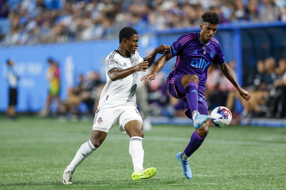 Charlotte FC defender Adilson Malanda, right, controls the ball next to Toronto FC forward Hugo Mbongue during the first half of an MLS soccer match in Charlotte, N.C., Wednesday, Oct. 4, 2023. (AP Photo/Nell Redmond)