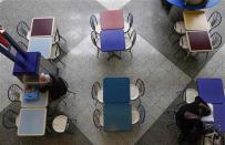 People sit at a dining area inside the central terminal of LaGuardia Airport in the Queens borough of New York April 8, 2014. REUTERS/Shannon Stapleton