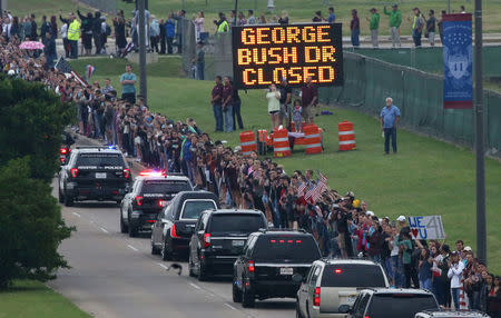 The motorcade for former first lady, Barbara Bush passes onlookers on George Bush Drive, followed by her husband, former U.S. President George H.W. Bush, son, former U.S. President George W. Bush, and their family to the George Bush Presidential Library and Museum for her burial in College Station, Texas, U.S., April 21, 2018. REUTERS/Spencer Selvidge
