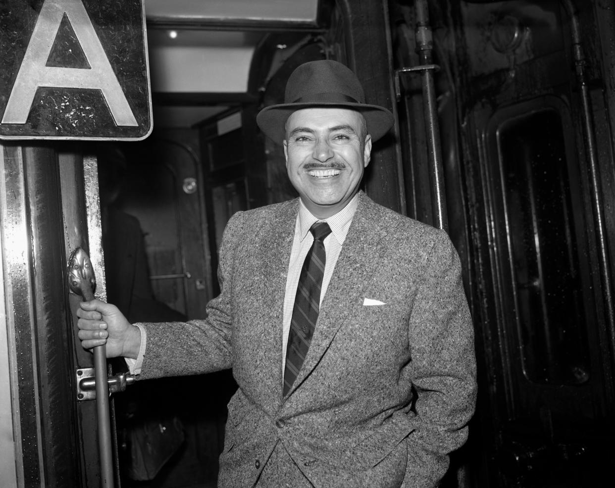 Pedro Armendariz, star of 100 Mexican films, is pictured at Waterloo Station as he left for Southampton to board the Cunard Liner Queen Mary on his way to the United States. Pedro Armendariz, who has made films in many different countries and languages, came to Britain to make his first British Film 'Manuela' with Trevor Howard (not pictured) and Italian actress Elsa Martinelli (not Pictured).   (Photo by PA Images via Getty Images)