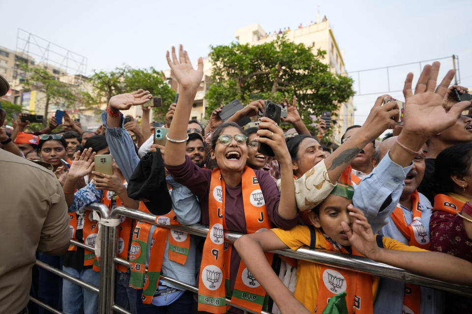 Supporters of Bharatiya Janata Party(BJP) react as they get a glimpse of Indian Prime Minister Narendra Modi during his roadshow in Varanasi, India, Monday, May 13, 2024. (AP Photo/Rajesh Kumar)
