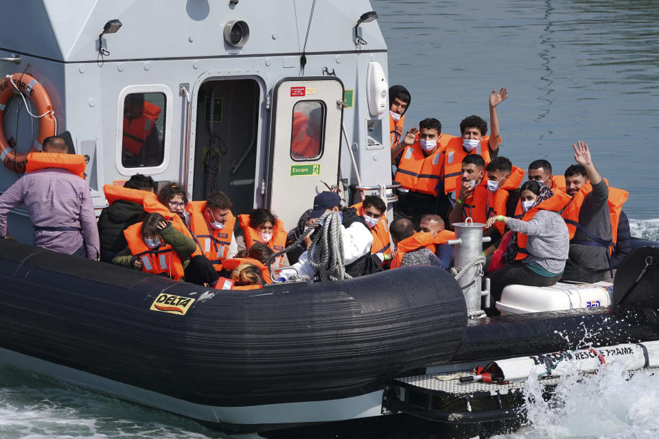 CORRECTING DATE - A group of people thought to be migrants are brought into port aboard a border force boat following a small boat incident in the Channel, at Dover, southern England, Wednesday July 21, 2021. According to information released Tuesday, the number of undocumented migrants reaching Britain in small boats this year has surpassed the total for all of 2020, as people smugglers take advantage of good weather to cross the English Channel from France. (Gareth Fuller/PA via AP)