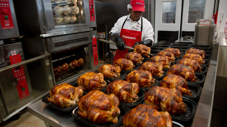 Costco deli worker packaging rotisserie chicken