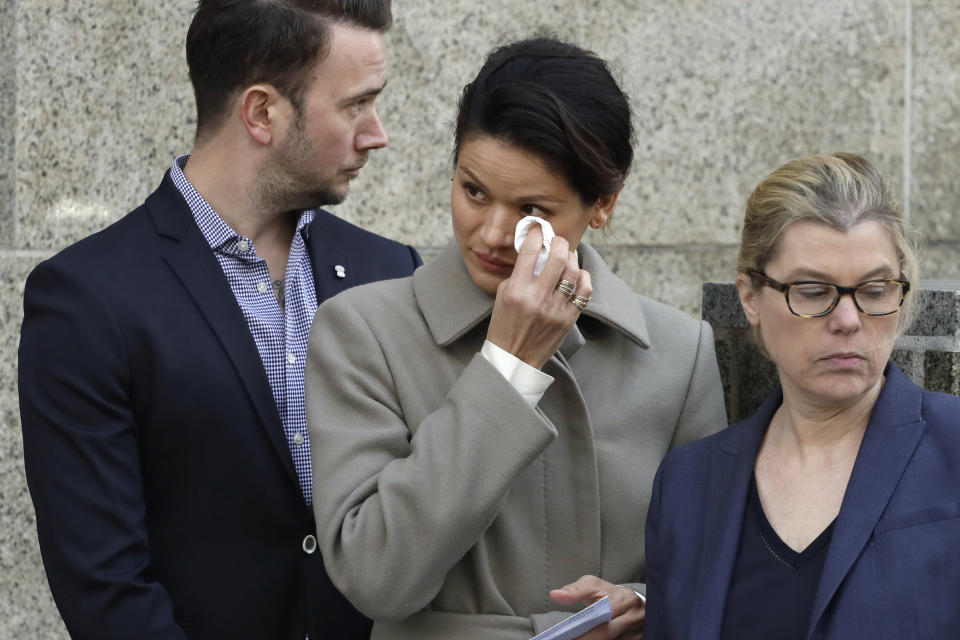 Tarale Wulff, center, wipes her eye before she speaks to the press after Harvey Weinstein's sentencing, in New York, Wednesday, March 11, 2020. Weinstein was sentenced to 23 years in prison for rape and sexual assault. During Weinstein's trial, Wulff testified that the one-time Hollywood titan raped her at his New York City apartment after luring her there in 2005 with promises of an audition for a film role. (AP Photo/Mark Lennihan)
