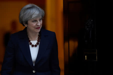 Britain's Prime Minister Theresa May walks out of 10 Downing Street to welcome Head of the European Commission, President Jean-Claude Juncker to Downing Street in London, Britain April 26, 2017. REUTERS/Hannah McKay