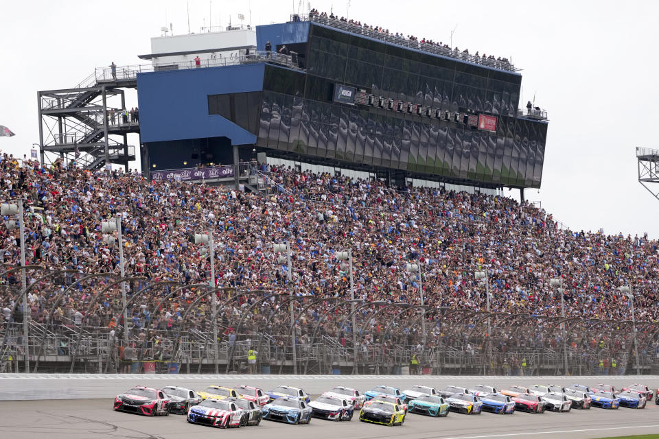 Christopher Bell (20) leads the field during a NASCAR Cup Series auto race at Michigan International Speedway in Brooklyn, Mich., Sunday, Aug. 6, 2023. (AP Photo/Paul Sancya)