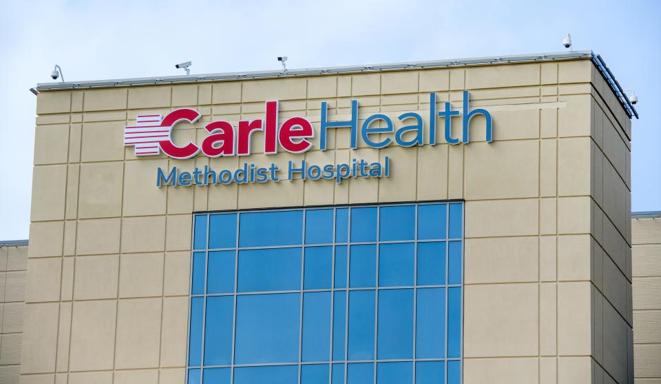 One of several new Carle Health signs hangs atop Methodist Hospital on Tuesday, April 4, 2023, in Peoria.