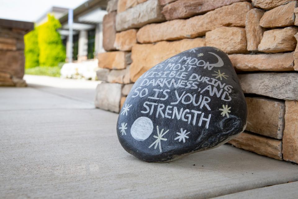 Stones painted with words of encouragement adorn pathways at the Serenity Lane campus in Coburg May 3, 2023. 