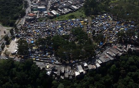 A general view shows shacks belonging to members of the Brazil's Homeless Workers' Movement (MTST) at the "People's World Cup" camp, which houses an estimate of 2,800 families of the movement, in the district of Itaquera near Sao Paulo's World Cup stadium, in Sao Paulo May 8, 2014. REUTERS/Paulo Whitaker
