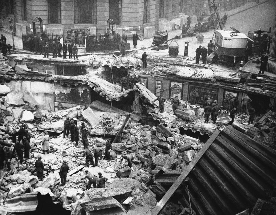 FILE - In this Sept. 9, 1940 file photo workmen crawl through the ruins of wrecked London flats to search for the dead after a Nazi bombing raid on London. The United Kingdom has suffered its worst civilian loss of life since World War II by a significant number. Some 70,000 non-combatants perished in the 1940s. 75 years later, it's 100,000 taken by the coronavirus pandemic, an enemy no less relentless and fearsome and one whose defeat is still some time away. (AP Photo, File)