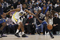 Minnesota Timberwolves guard Patrick Beverley, right, handles the ball against Golden State Warriors forward Andrew Wiggins, left, during the first half of an NBA basketball game Sunday Jan. 16, 2022, in Minneapolis. (AP Photo/Stacy Bengs)