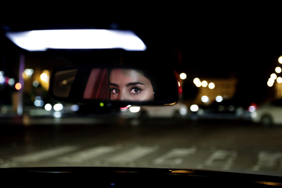 Hessah al-Ajaji drives her car down the capital's busy Tahlia Street after midnight for the first time in Riyadh, Saudi Arabia, Sunday, June 24, 2018. (AP Photo/Nariman El-Mofty)