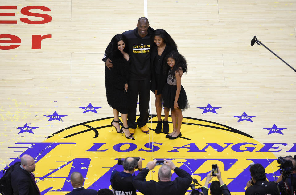 FILE - In this April 13, 2016, file photo, Los Angeles Lakers' Kobe Bryant poses for pictures with his wife Vanessa, left, and daughters Natalia, second from right, and Gianna as they stand on the court after an NBA basketball game against the Utah Jazz, in Los Angeles. Kobe Bryant's legacy may be stronger than ever. Tuesday, Jan. 26, 2021, marks the anniversary of the crash that took the lives of Bryant, Gianna and seven other people. (AP Photo/Mark J. Terrill, File)