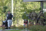 RCMP officers prepare to enter an apartment complex in connection with the mailing of ricin to President Trump Monday, Sept. 21, 2020 in St. Hubert, Canada. (Ryan Remiorz/The Canadian Press via AP)