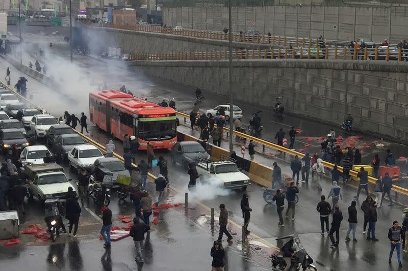 FILE PHOTO: People protest against increased gas price, on a highway in Tehran