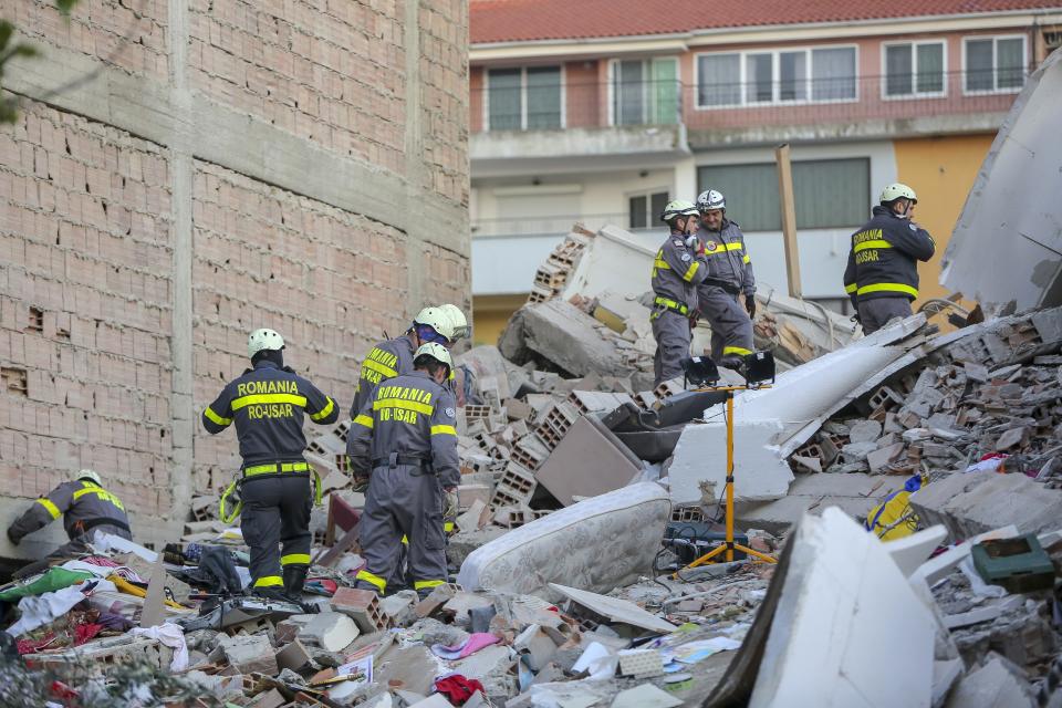 Rescuers search a damaged building in Durres, western Albania, Wednesday, Nov. 27, 2019. The death toll from a powerful earthquake in Albania has risen to 25 overnight as local and international rescue crews continue to search collapsed buildings for survivors. (AP Photo/Visar Kryeziu)