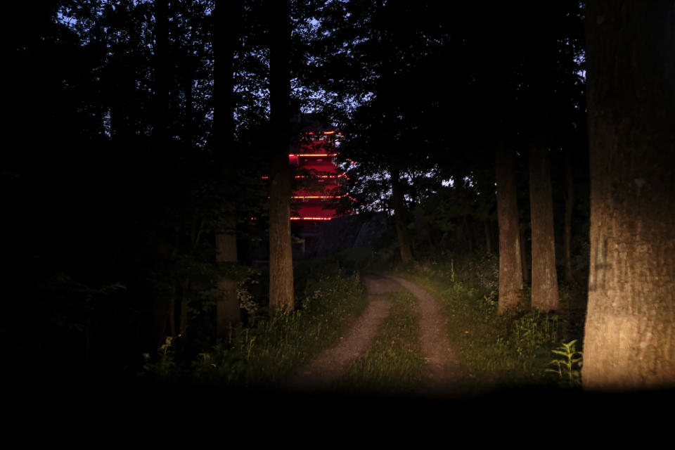 The Reading Pagoda, a historic landmark and symbol of the city in Pennsylvania for more than a century is illuminated at night atop Mount Penn, Pa., on Sunday, June 16, 2024. (AP Photo/Luis Andres Henao)