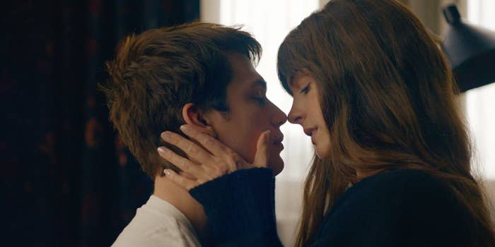 Nicholas Galitzine, Anne Hathaway share a close moment, one with a hand on the other's cheek, in an intimate scene from The Idea of You