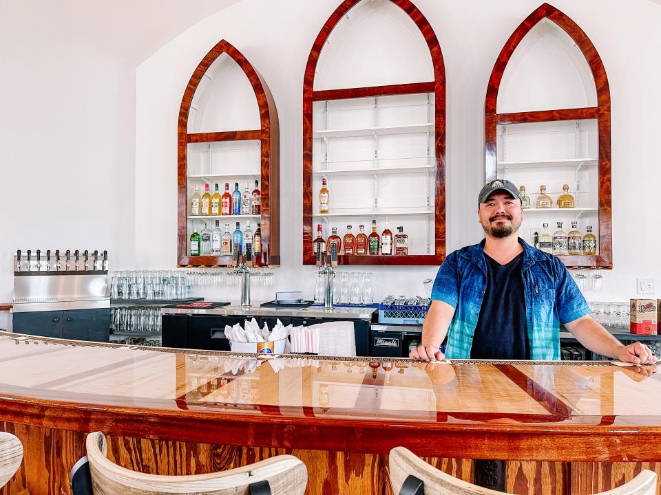 Zach Bowlby, one of the managing partners of 71 South, behind the handcrafted bar in South Knoxville, April 6, 2023.