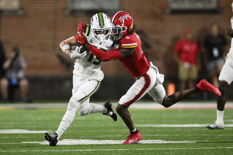 Maryland defensive back Corey Coley Jr., right, tackles Charlotte wide receiver Jack Hestera, left, during the first half of an NCAA college football game, Saturday, Sept. 9, 2023, in College Park, Md. (AP Photo/Nick Wass)