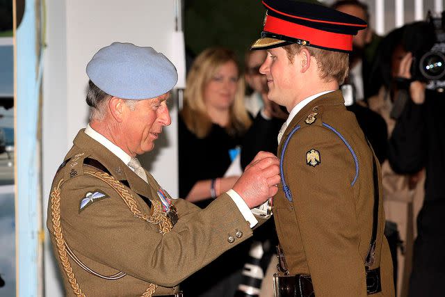 <p>Chris Jackson/Getty Images</p> Then-Prince Charles presents Prince Harry with his flying wings at the at the Army Aviation Centre on May 7, 2010 in Andover, England.