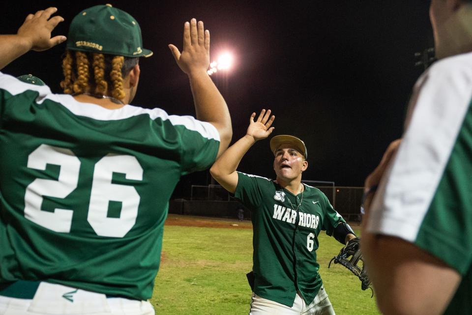 Jupiter second baseman Mason Barela (6) hi fives Jupiter outfielder A.J. Crespo (26) celebrating victory after the end of the District 11-7A championship baseball game between host Jupiter and Palm Beach Central on Thursday, May 4, 2023, in Jupiter, Fla. Final score, Jupiter, 11, Palm Beach Central, 3.