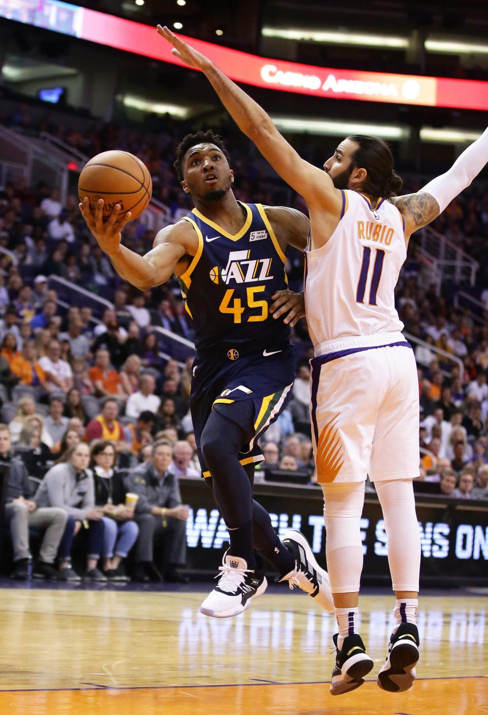 Utah Jazz guard Donovan Mitchell (45) drives to the basket against Phoenix Suns guard Ricky Rubio (11) in the first half on Oct. 28, 2019 in Phoenix, Ariz.